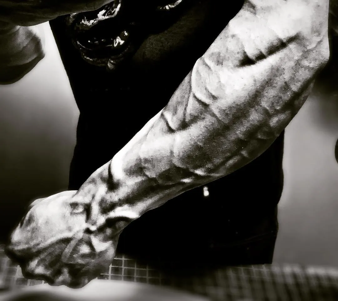 Black and white close-up of a climber's forearm with prominent veins